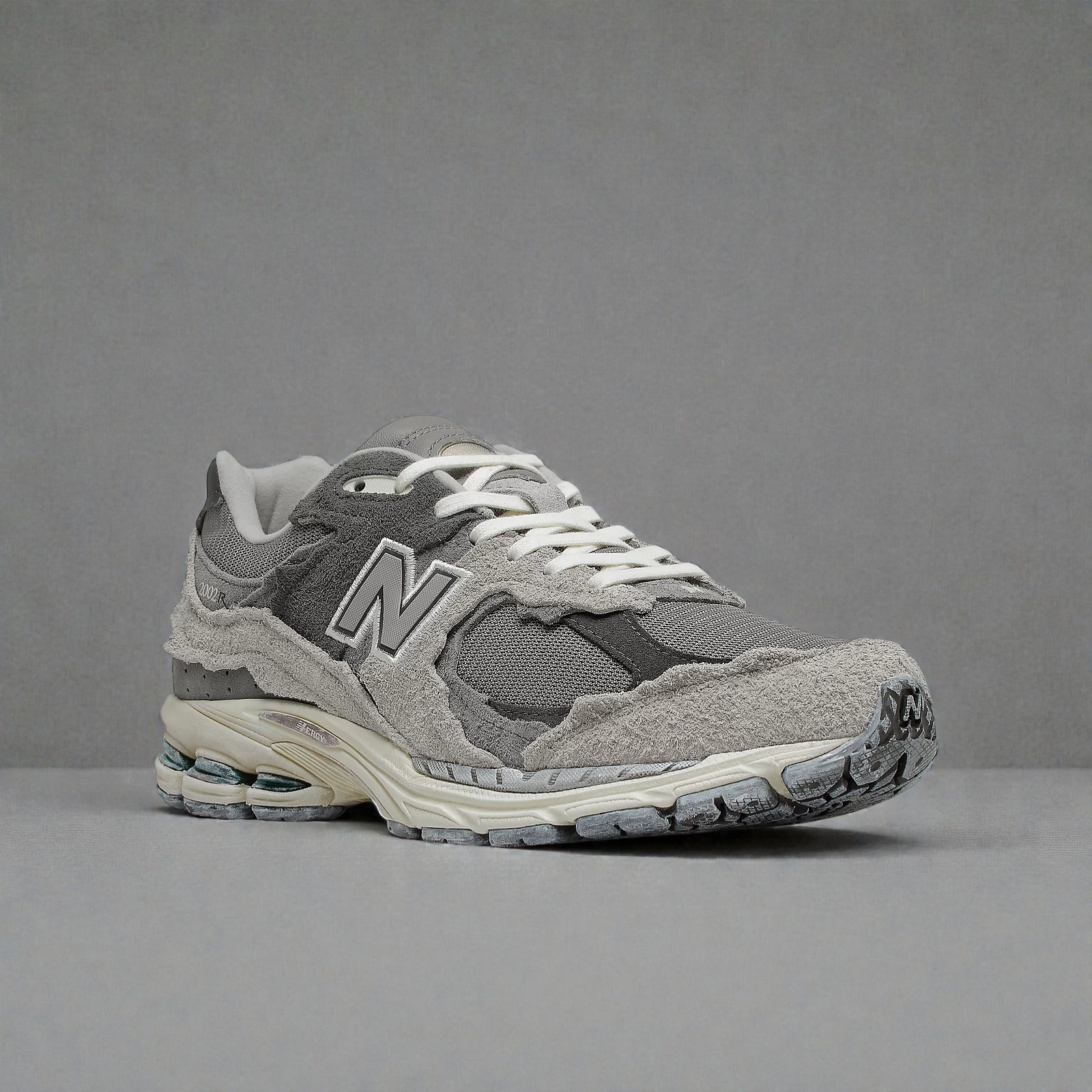 Plugmarket - New Balance 2002R Protection Pack Rain Cloud sneakers in grey suede and mesh with distressed detailing.