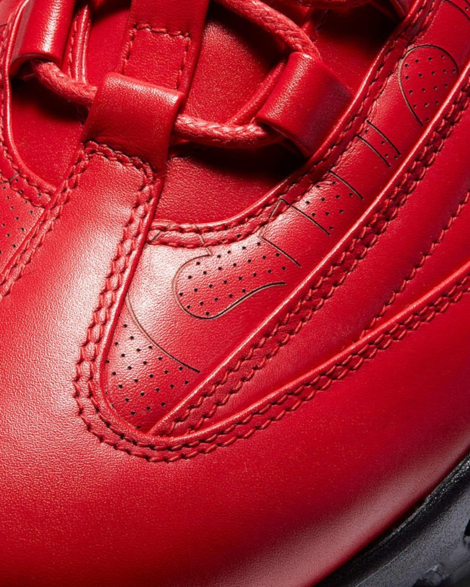 Plugmarket - Nike x Supreme Air Max 95 Lux Gym Red leather sneakers with perforated details and stitched accents.